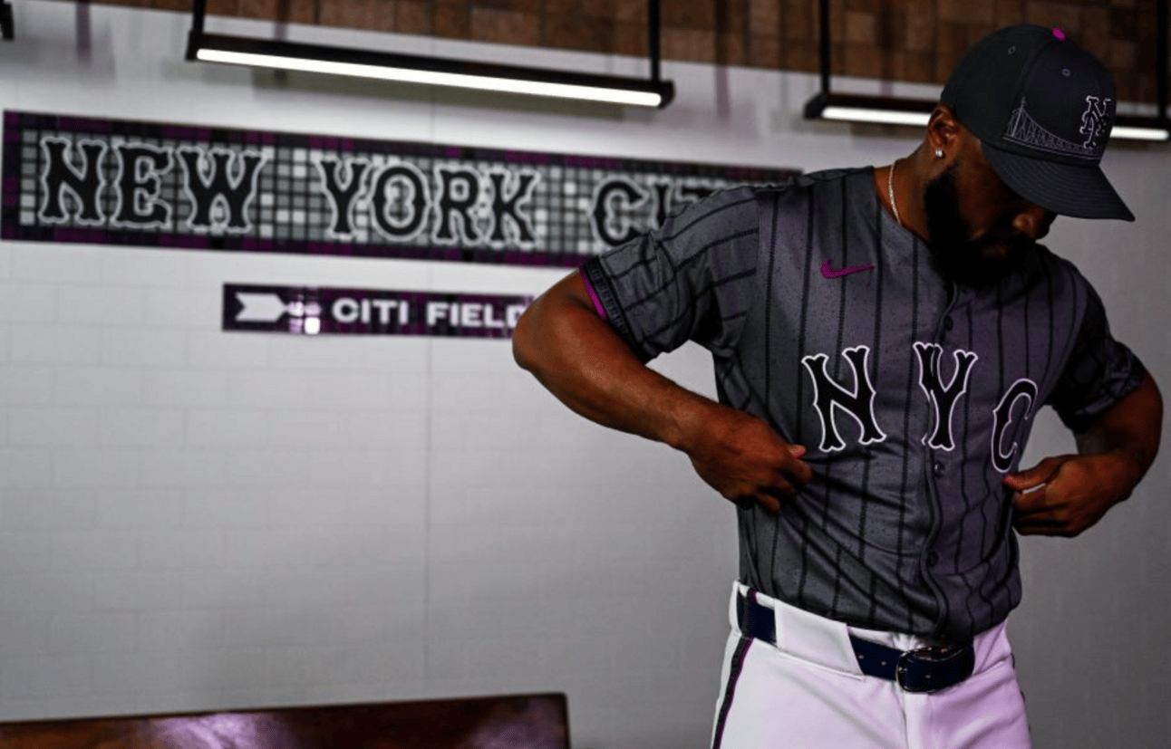 Gray pinstriped top with NYC written on them and white pants