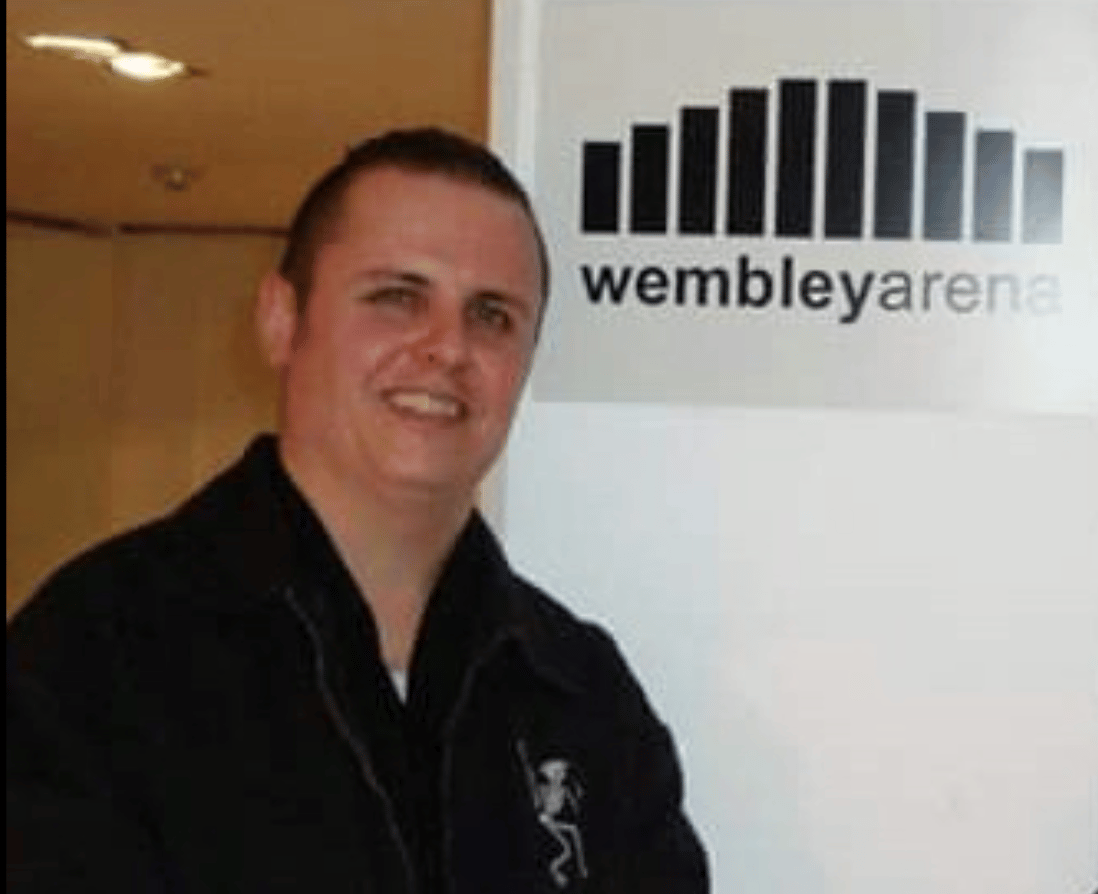 PMy brother standing in front of the sign for Wembley Arena