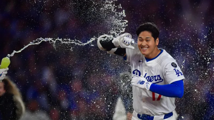 Shohei Ohtani has water splashed on him as he heads home after a walkoff home run