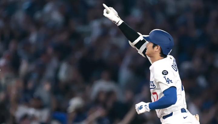 Shohei Ohtani with one arm up in the air in celebration after hitting one of his two home runs