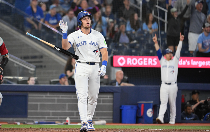 Addison Barger flips his bat after hitting a walkoff home run