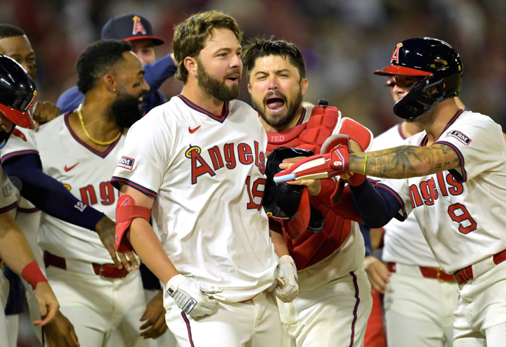 Nolan Schanuel being mobbed by his teammates after drawing a walkoff walk