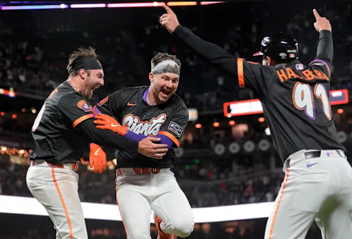 Patrick Bailey of the Giants with a teammate and a base coach, celebrating his walkoff homer