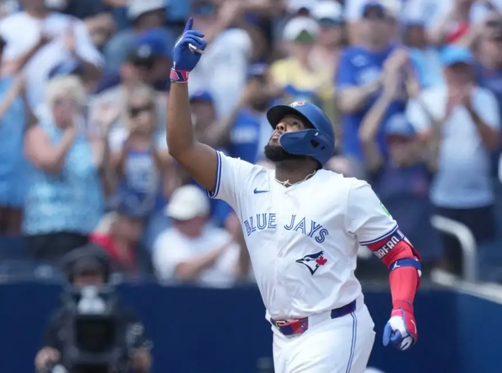 Vlad Guerrero pointing up at the sky as he rounds the bases following a home run