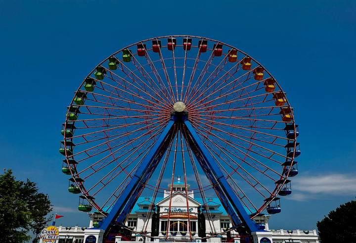 A ferris wheel against a blue sky