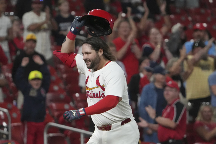 Alex Burleson throwing off his batting helmet as he rounds the bases following a walkoff home run