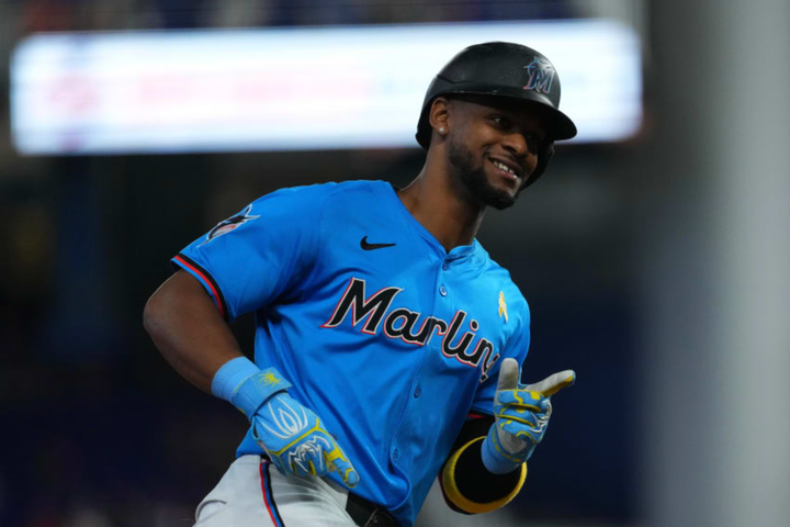Otto López of the Marlins smiling and pointing into his dugout while rounding the bases after hitting one of this two home runs yesterday