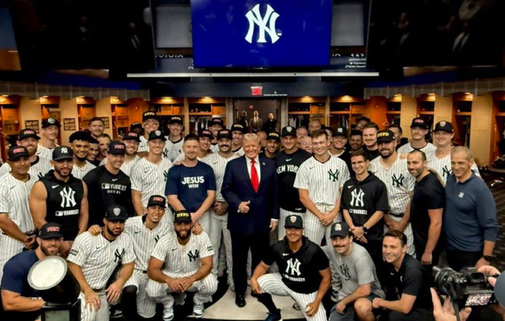Trump in the Yankees clubhouse posing with the whole team