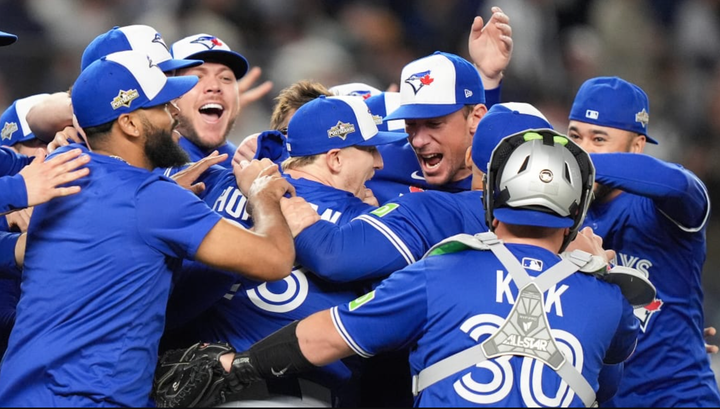 Blue Jays celebrate on the field after winning the ALDS