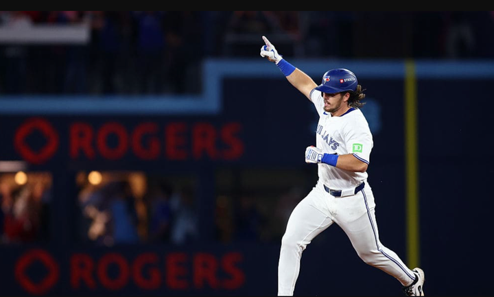 Addison Barger with his arm raised in the air after hitting a home run