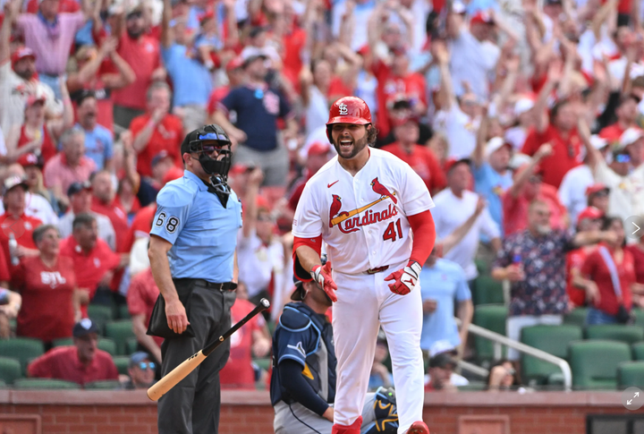 Alex Burelson flexing after hitting a game-tying homer