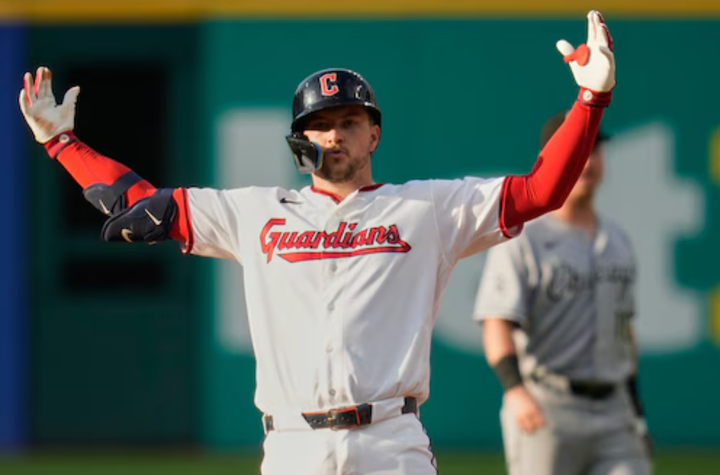 Brayan Rocchio with his arms up in, um, triumph?