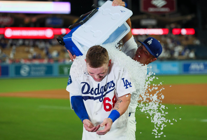 Dalton Rushing getting a cooler of ice poured on him by a teammate