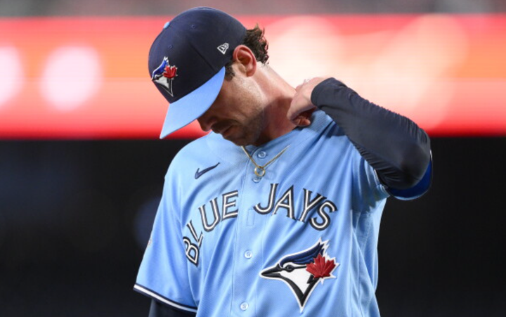 Shane Bieber pulling at his collar 
