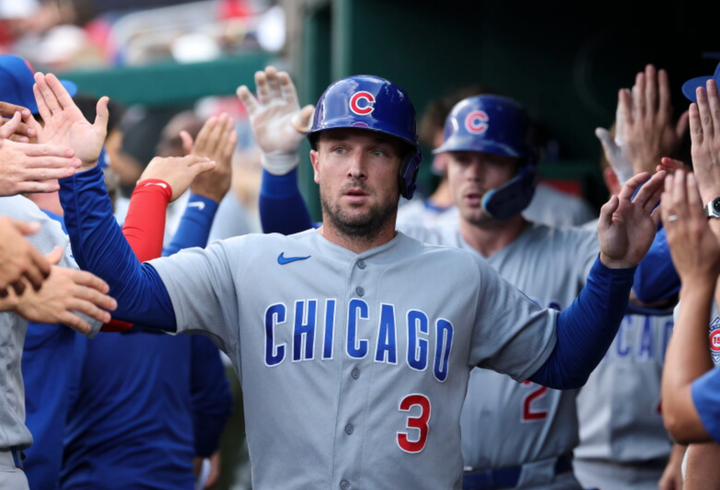 Alex Bregman high-fiving his teammates in the dugout