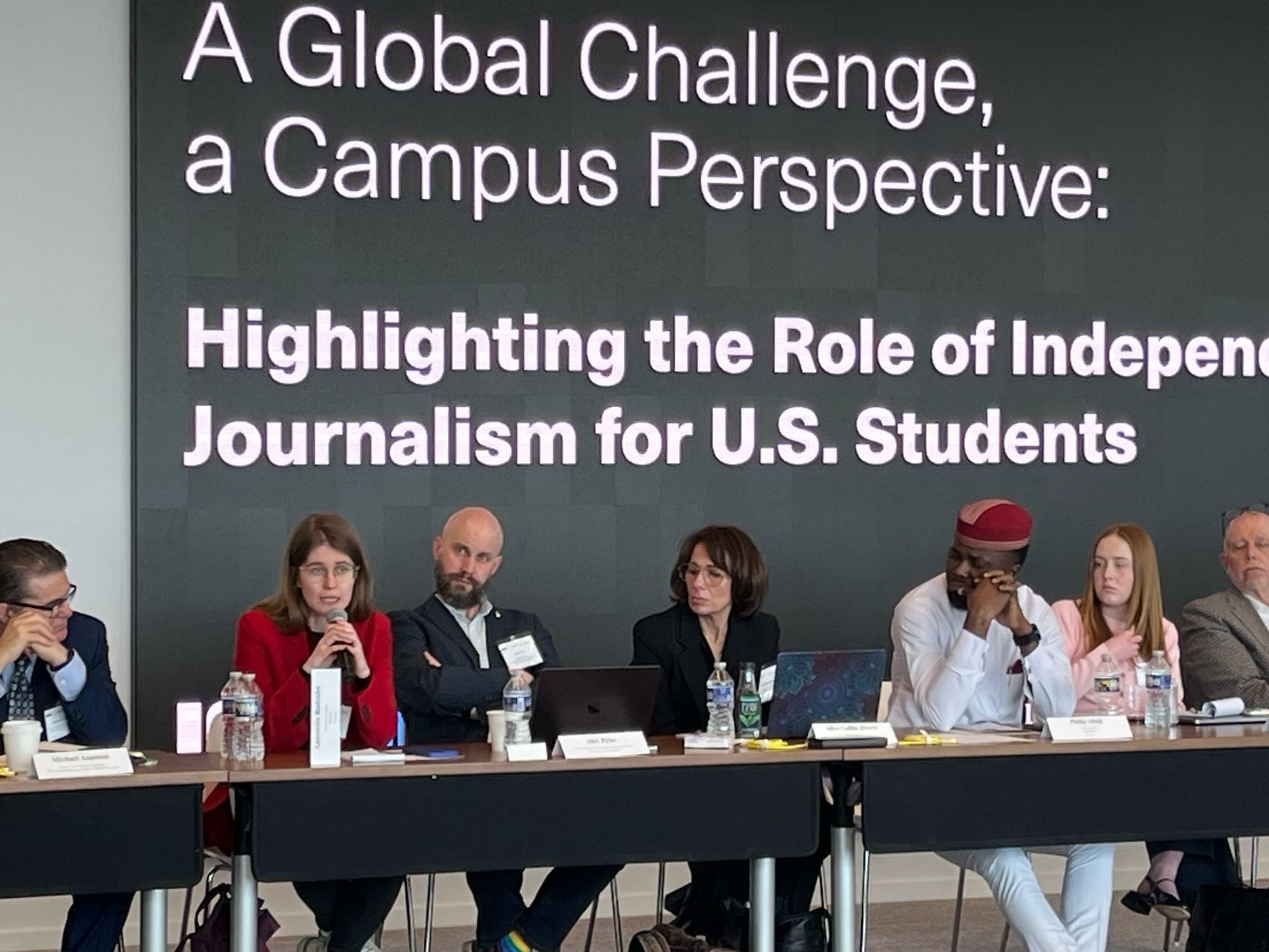 Anastasia speaking into a mic at the roundtable.