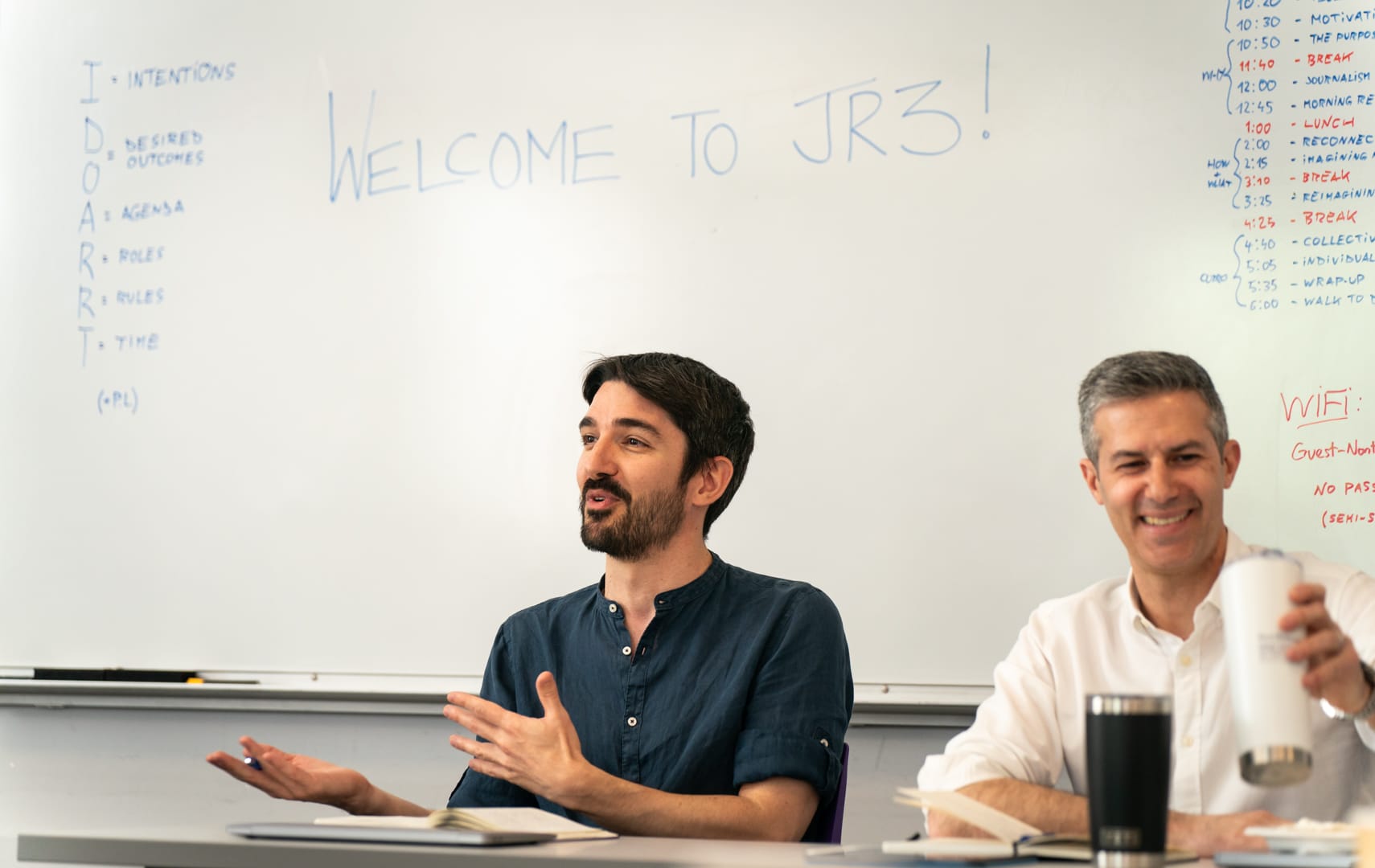 Mattia and Jeremy sitting infront of a white board