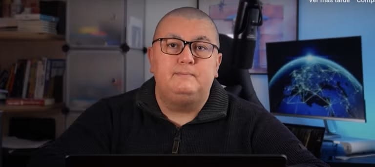 Luis Assardo sitting at a computer