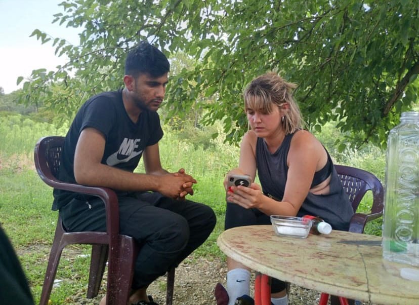 Marta interviewing a man in the Balkan route.