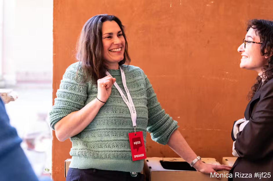 Two women smiling and talking.