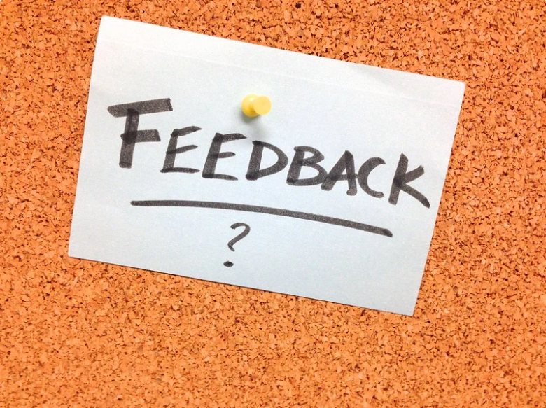 A paper that says Feedback and is tacked to a board.