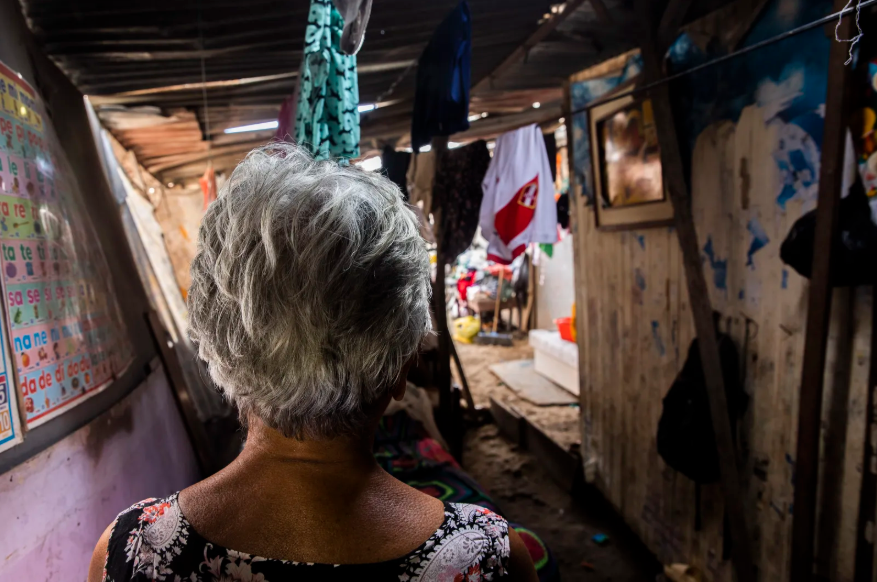 An older woman looking into an alley.