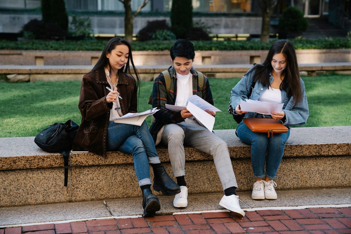 Students sitting outside and studying.