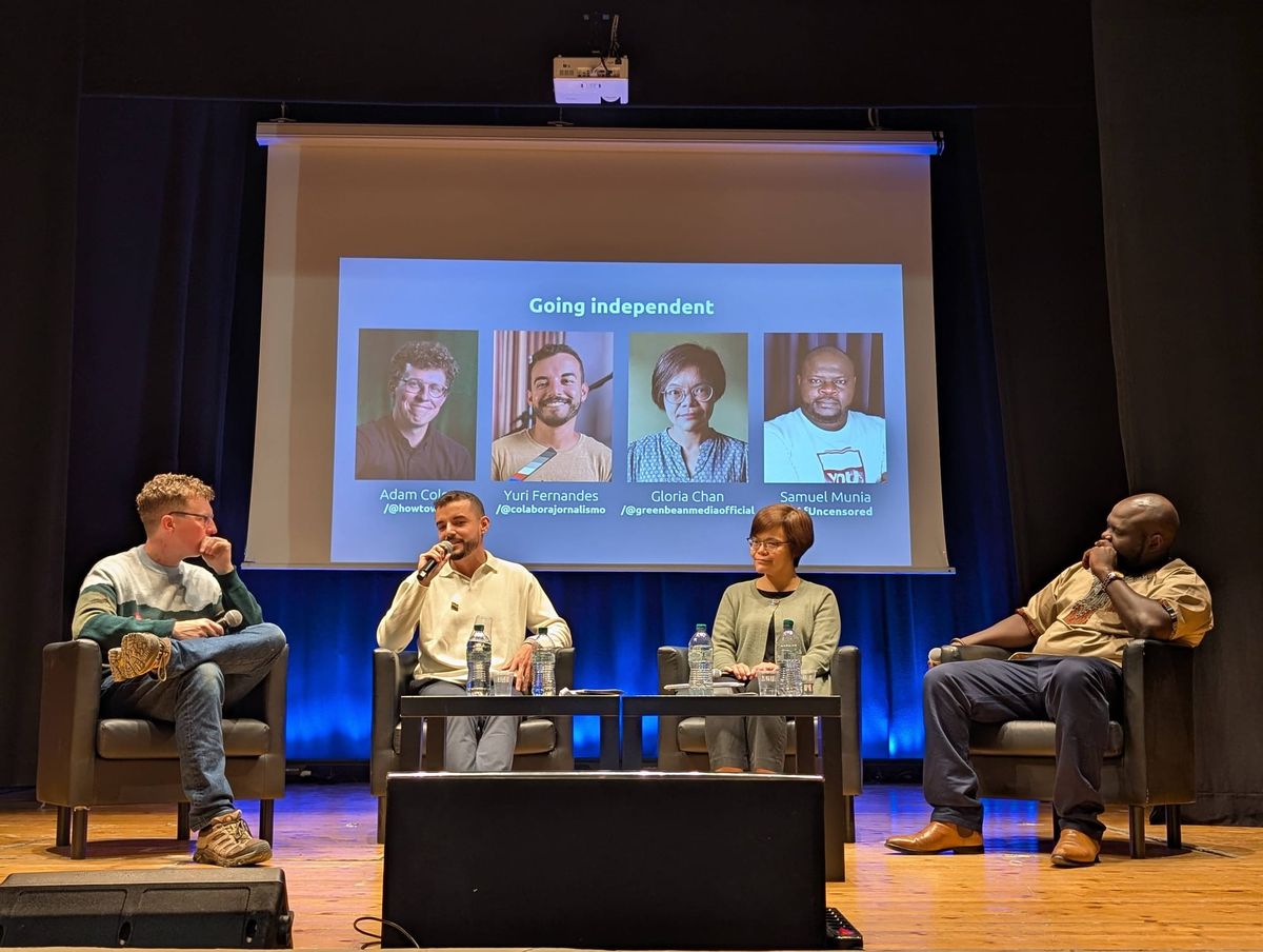 Adam Cole, Yuri Fernandes, Gloria Chan, and Samuel Munia sitting in front of a screen with their names on in it. 