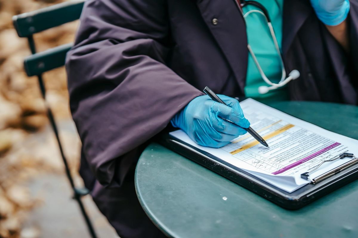 A doctor filling out a health form