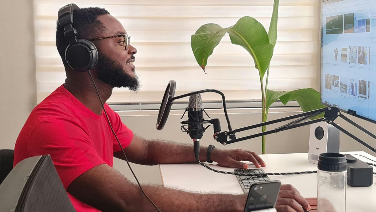 A man sitting in front of podcast equipment