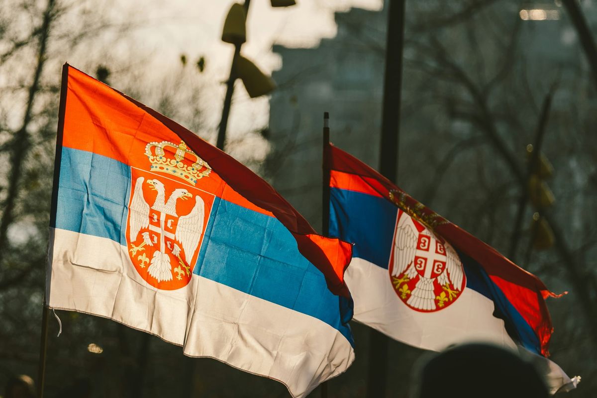 Two Serbian flags blowing in the wind.