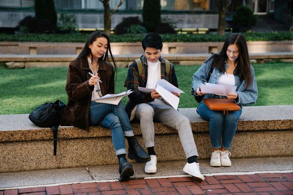 Students sitting outside and studying.