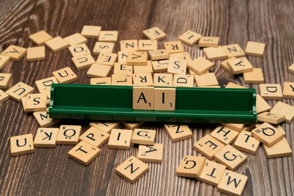 Scrabble pieces that spell AI.