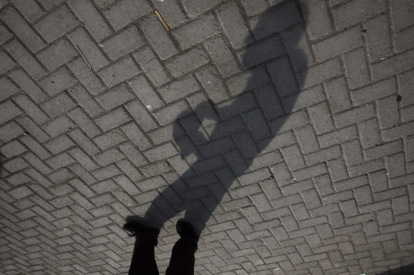 A man's shadow captured on the ground