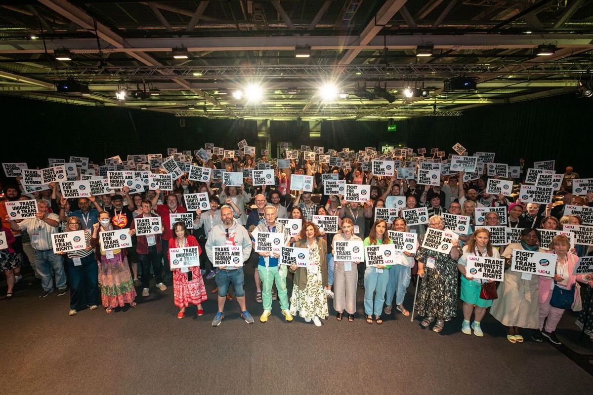 UCU Congress delegates holding signs saying 'Trans Rights are Human Rights' and 'Fight for Trans Rights'