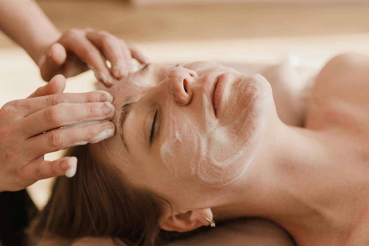 Woman getting a facial from an Esthetician