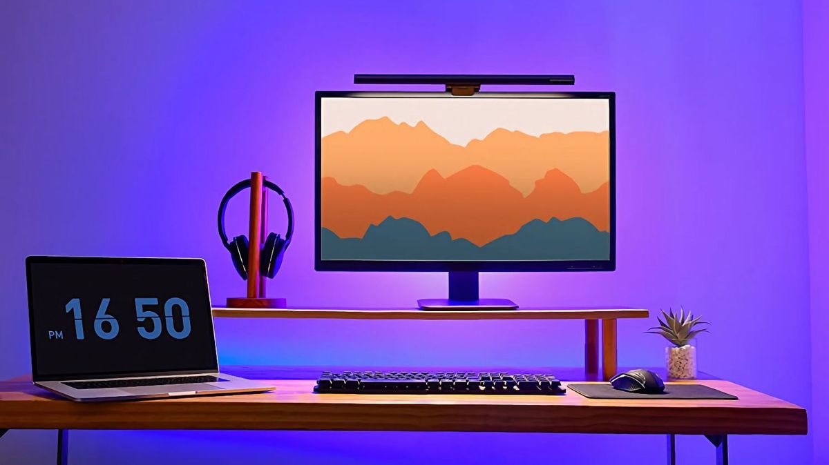 desk setup showing MacBook Pro and a monitor with monitor light bar
