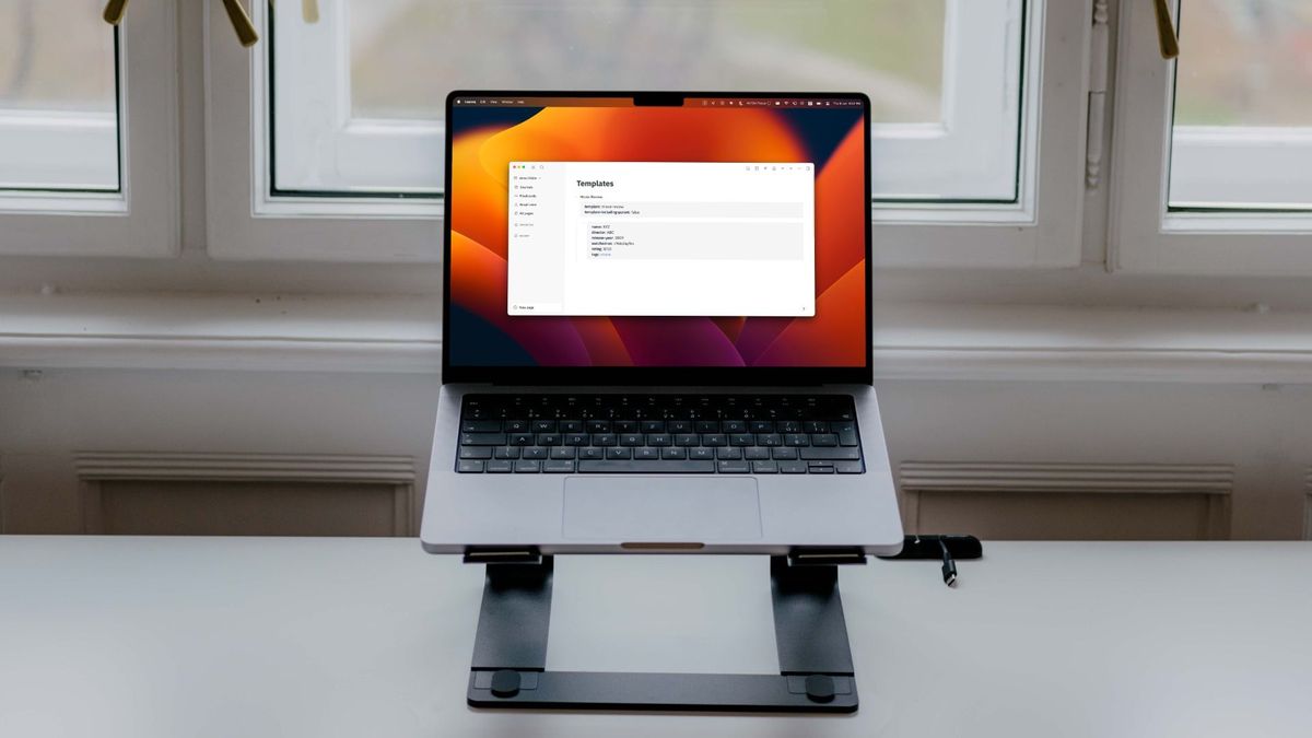 Logseq open in 14-inch MacBook Pro sitting on stand with window as background