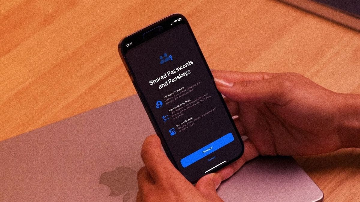 lady holding iPhone in hand showcasing password sharing feature