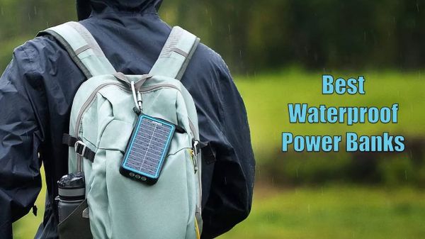 Man standing in rain with a waterproof power bank attached to his backpack