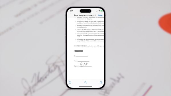 Sign a PDF on iPhone featured image showing iPhone with a signed PDF