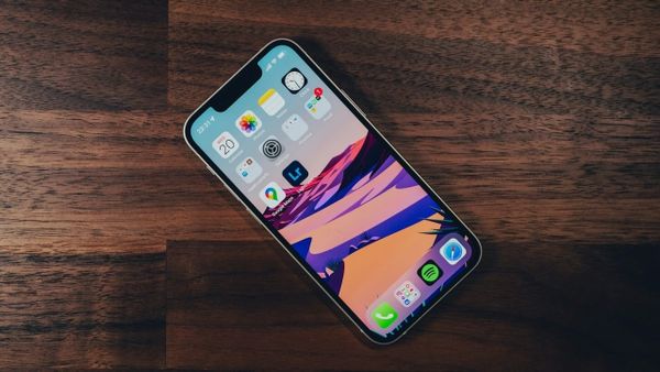 iPhone 13 mini on wooden table