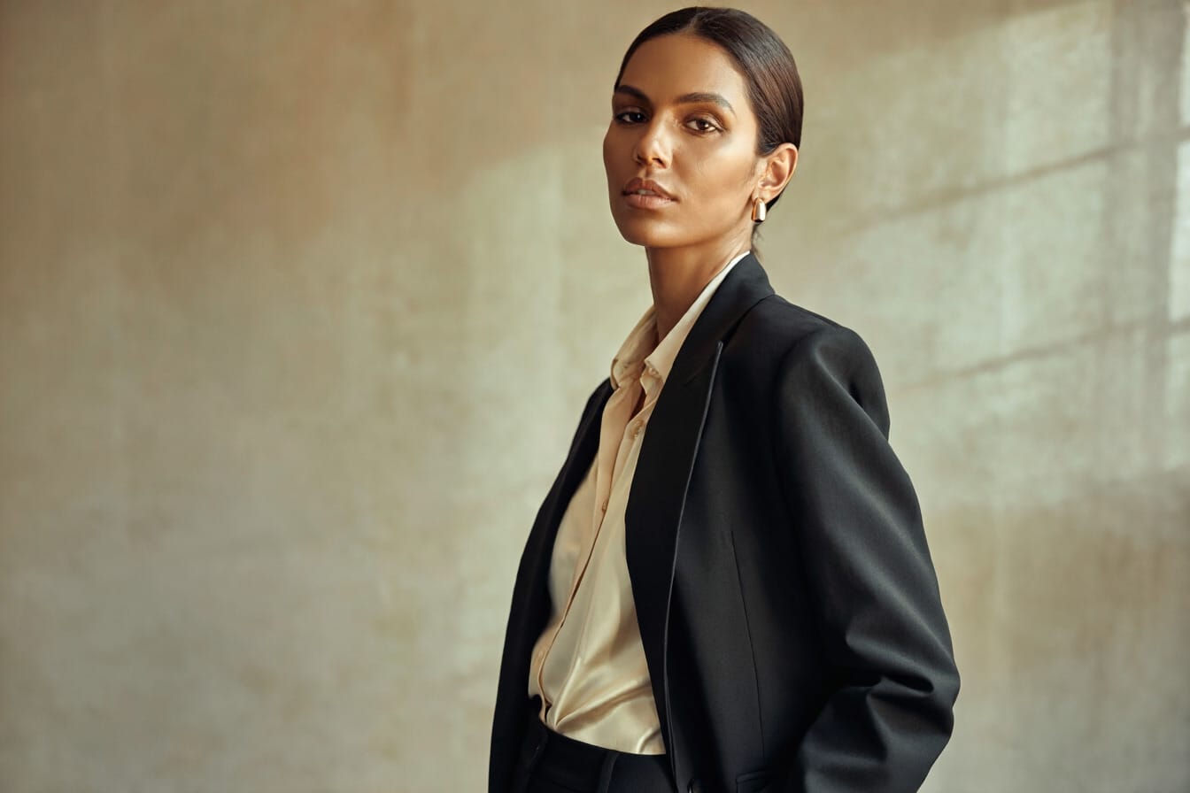 Editorial portrait with strong expression, wardrobe, background, and facial lighting.