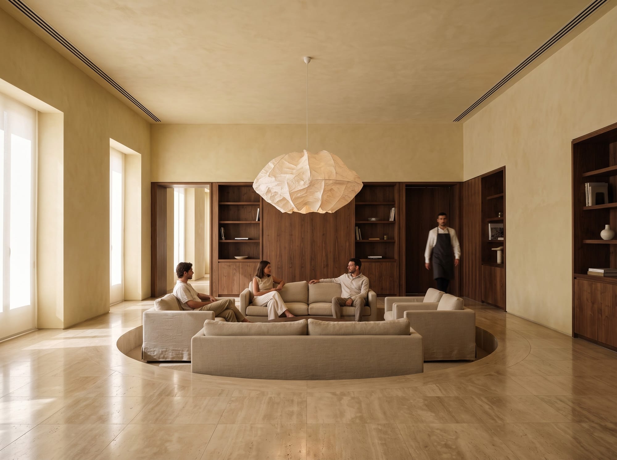 Warm contemporary boutique hotel lobby with a central sunken lounge.
