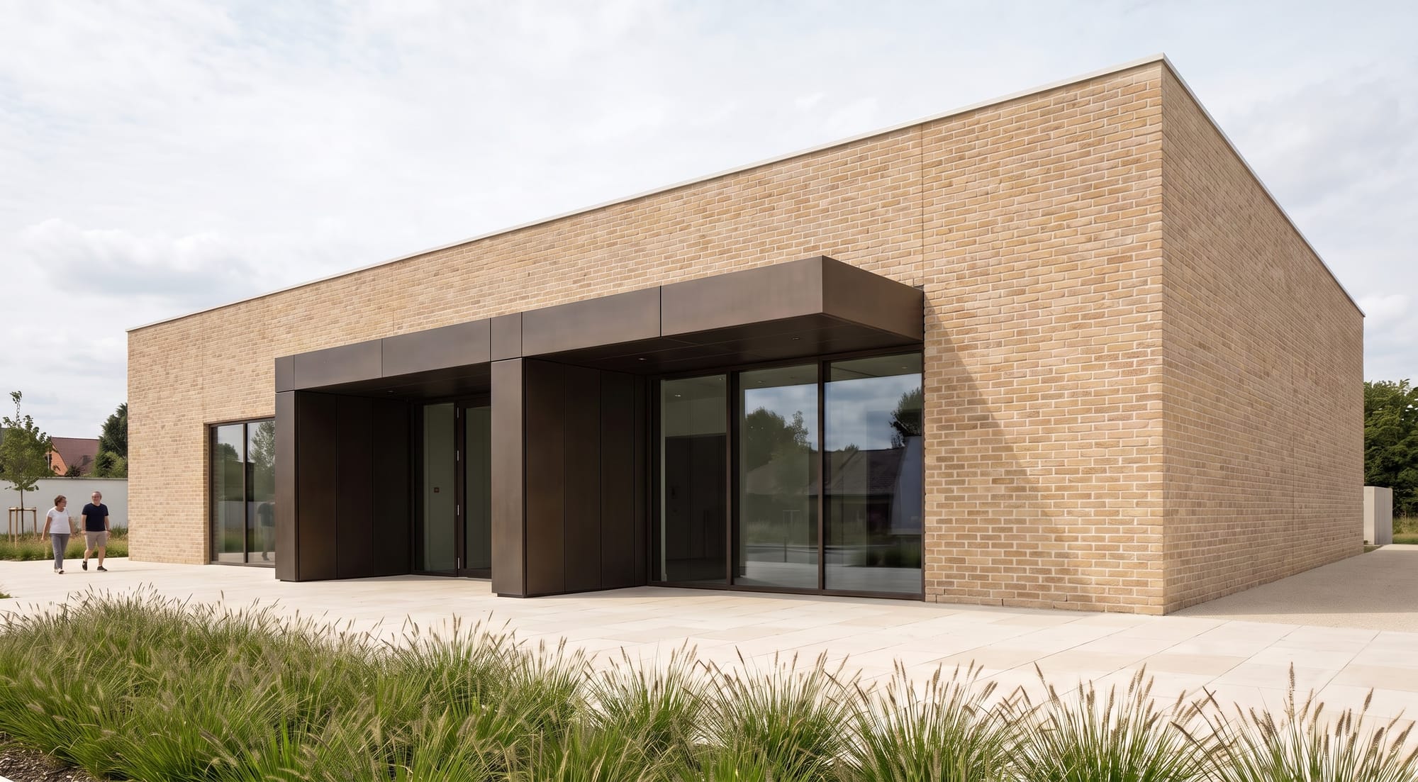 Cultural pavilion facade edited to warm buff brick with bronze-framed openings.