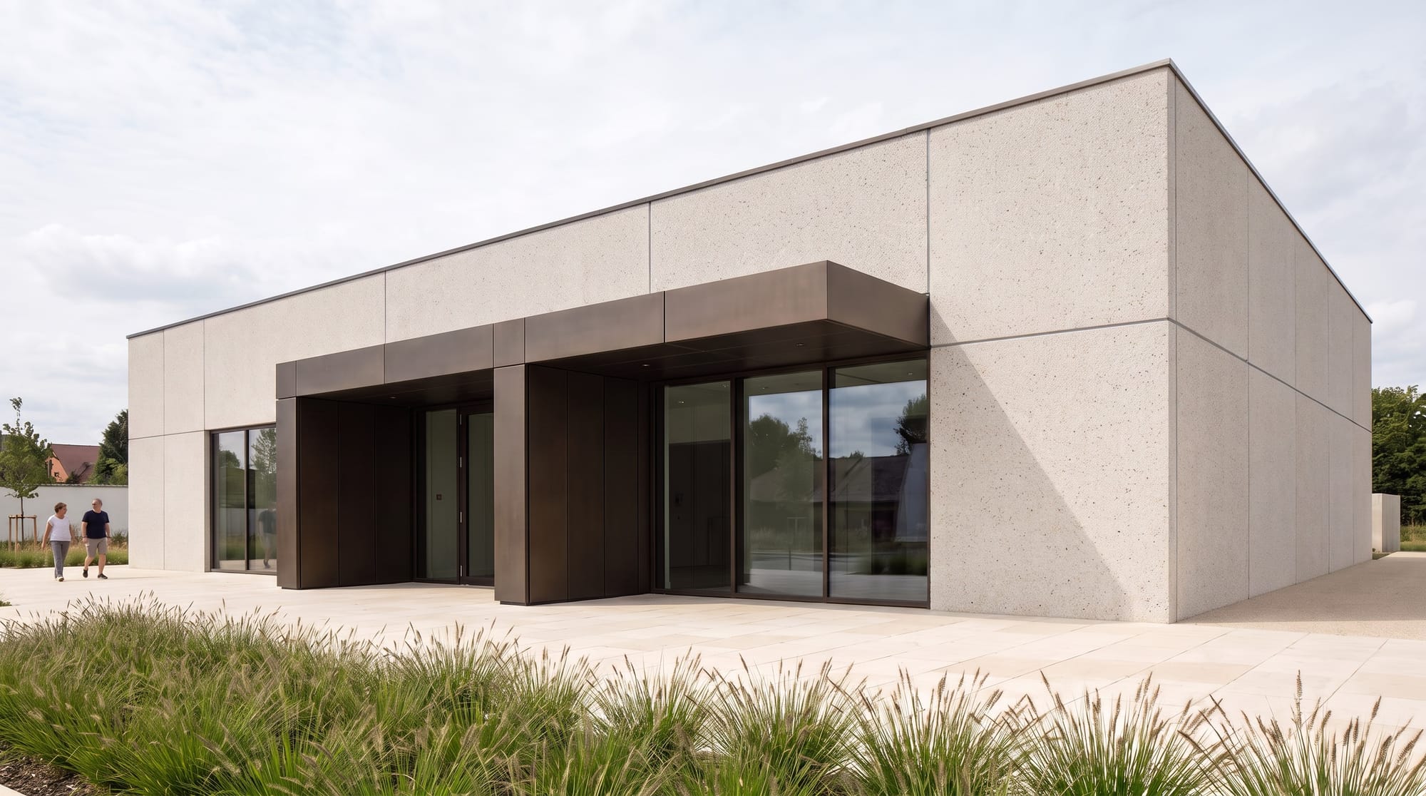 Cultural pavilion facade edited to pale precast concrete panels with dark joints.