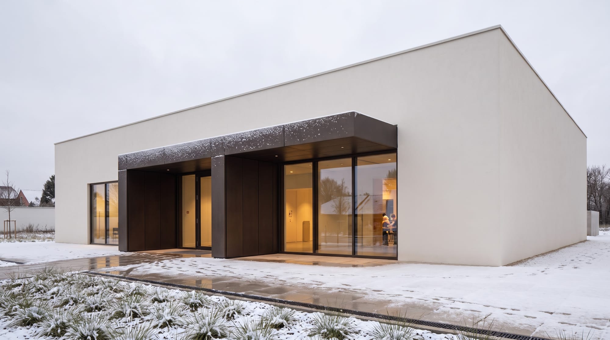 Contemporary pavilion adapted to an early-winter scene with light snow and bare vegetation.