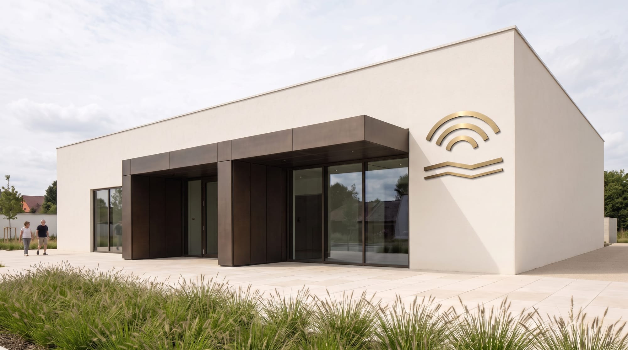 Geometric brushed brass river and arch logo installed entirely on the marked flat front facade.