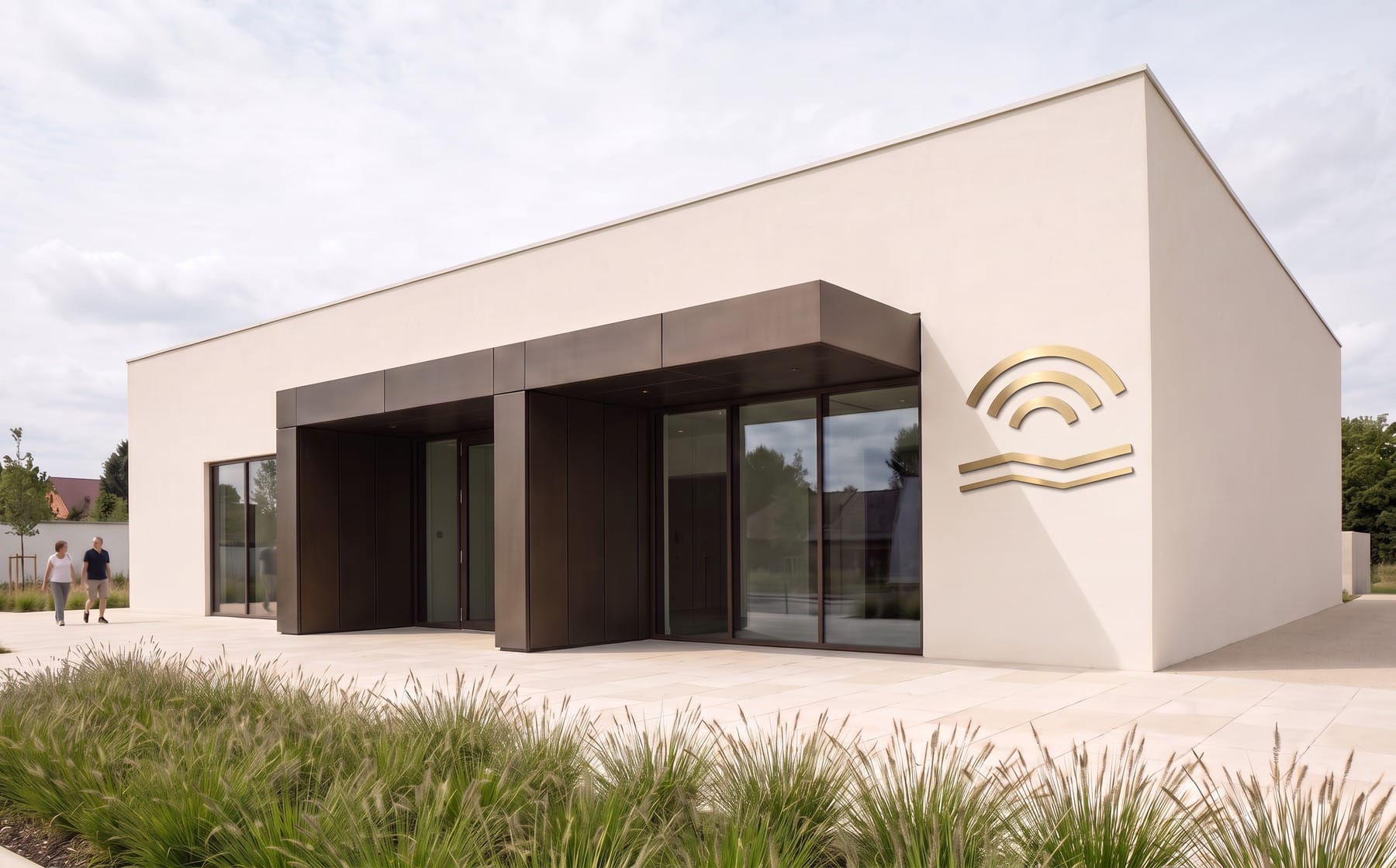 Geometric brushed-brass river-and-arch logo mounted on the architectural facade.