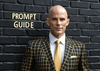 A james bond style villian that looks similar to Adam Stewart with text "Prompt Guide" in the top left.